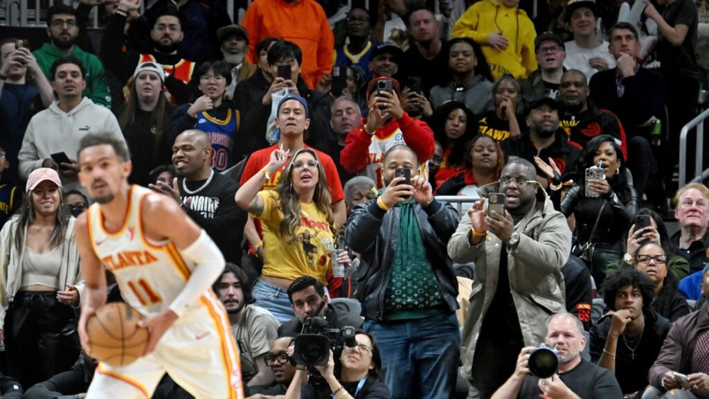 Fans capturing Basketball match moments on their phones
